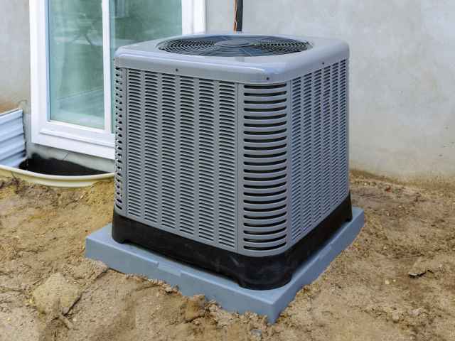 Air conditioning system unit installed outside facade of the house Air conditioning system unit installed outside facade of the house